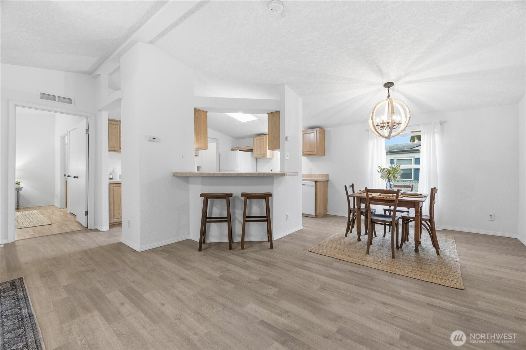 579 Lupine Lane, Unit 16 Burlington, WA 98233 - Photo 17 of 37 a view of a dining room with furniture and wooden floor