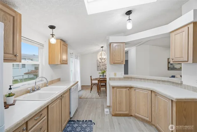 a kitchen with a refrigerator sink and cabinets