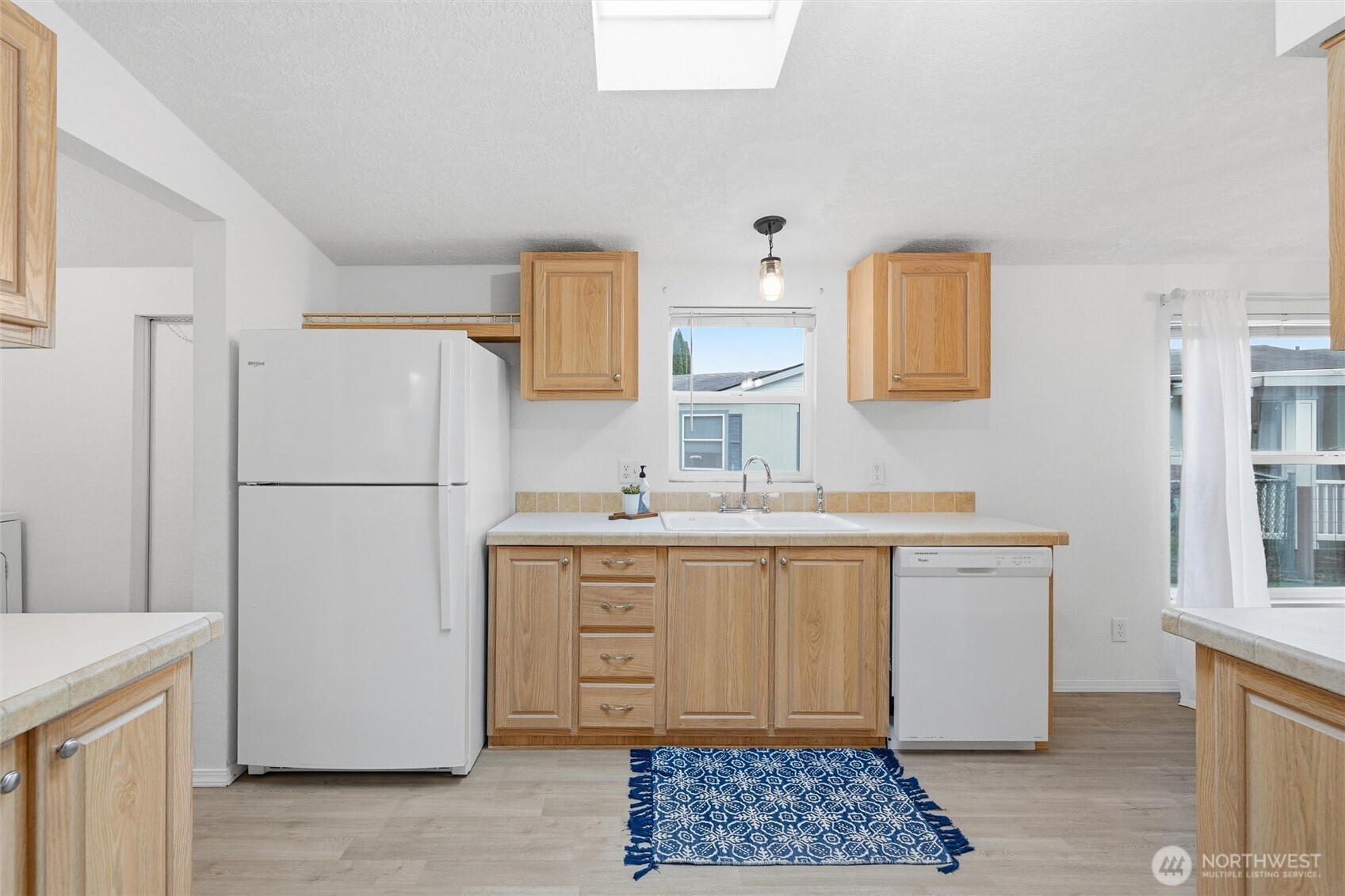 579 Lupine Lane, Unit 16 Burlington, WA 98233 - Photo 20 of 37 a kitchen with a refrigerator sink and cabinets