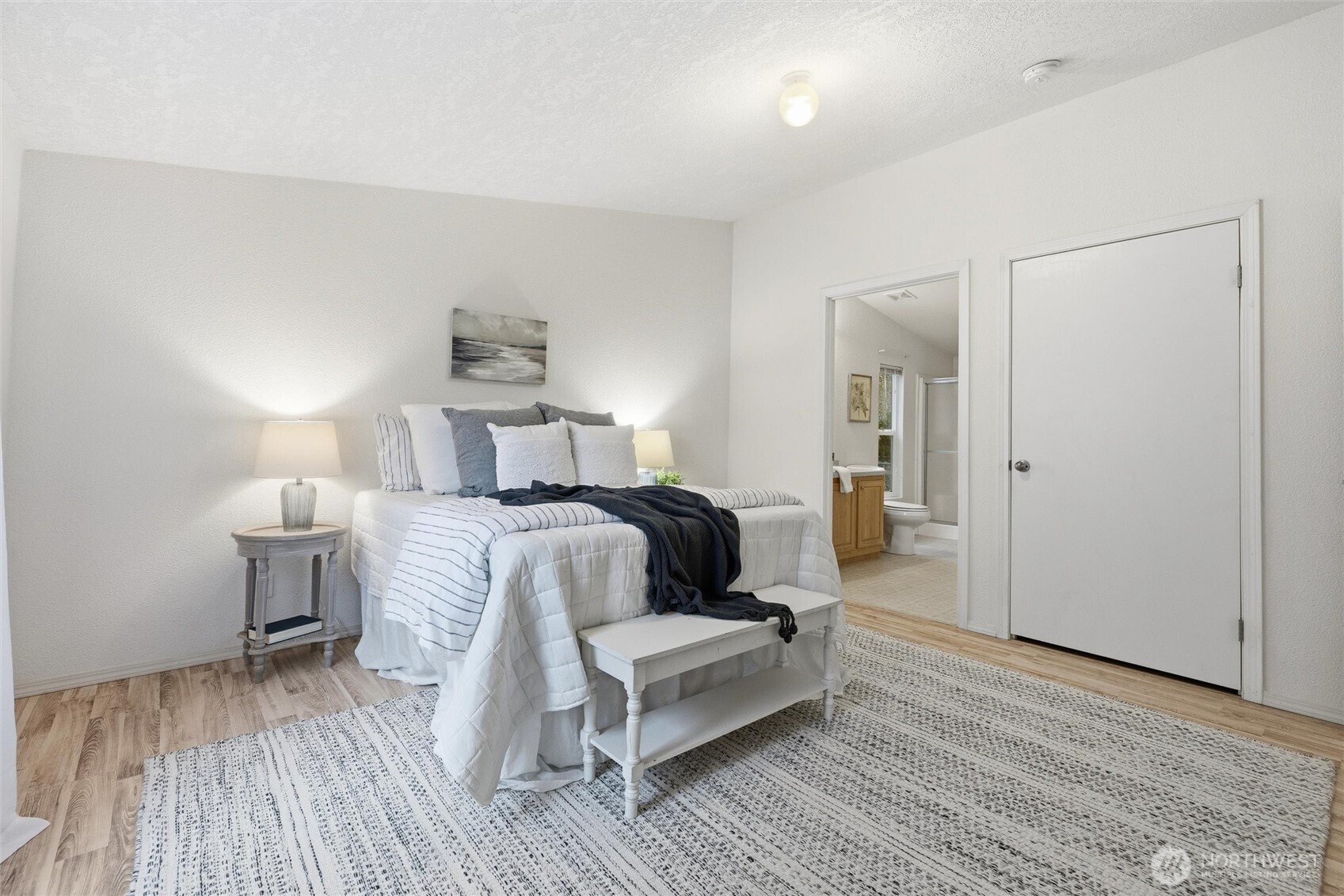 579 Lupine Lane, Unit 16 Burlington, WA 98233 - Photo 21 of 37 a bedroom with a bed and wooden floor