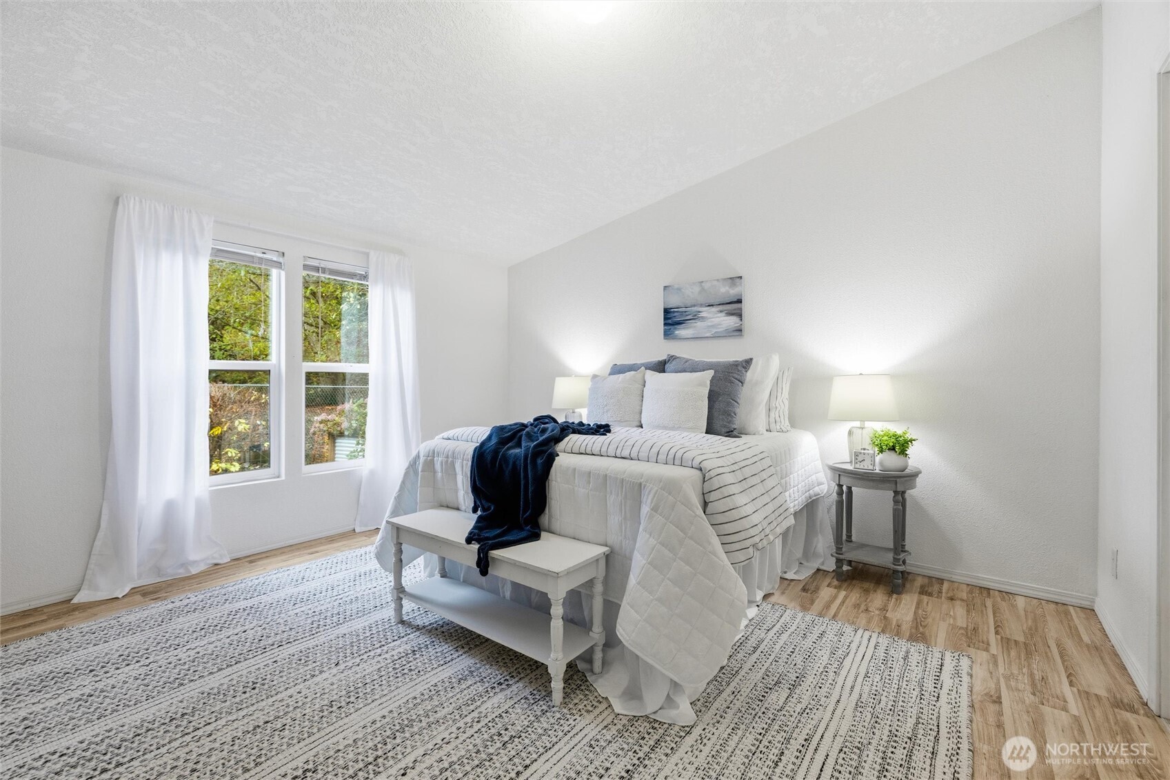 579 Lupine Lane, Unit 16 Burlington, WA 98233 - Photo 22 of 37 a bedroom with a bed and wooden floor