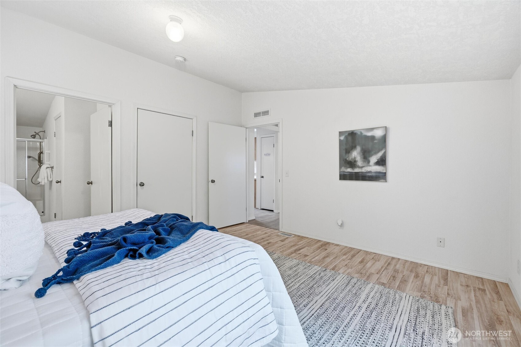 579 Lupine Lane, Unit 16 Burlington, WA 98233 - Photo 23 of 37 a bedroom with a bed and a painting on the wall