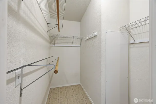 a bathroom with a granite countertop sink a toilet a mirror and shower