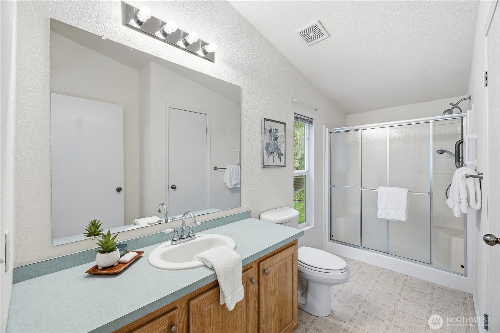 579 Lupine Lane, Unit 16 Burlington, WA 98233 - Photo 25 of 37 a bathroom with a granite countertop sink a toilet a mirror and shower