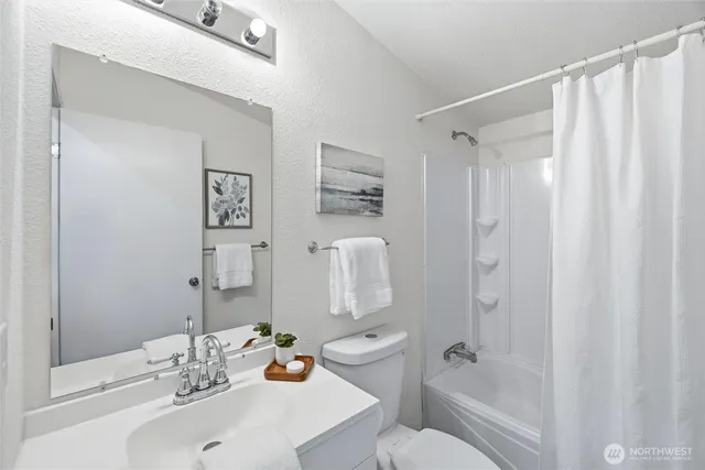 a utility room with cabinets washer and dryer