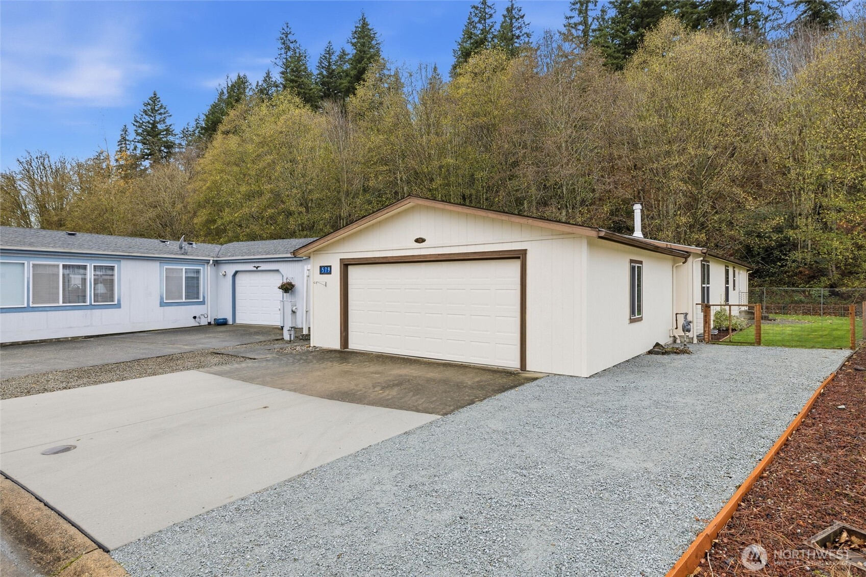 579 Lupine Lane, Unit 16 Burlington, WA 98233 - Photo 5 of 37 a front view of a house with a yard and garage