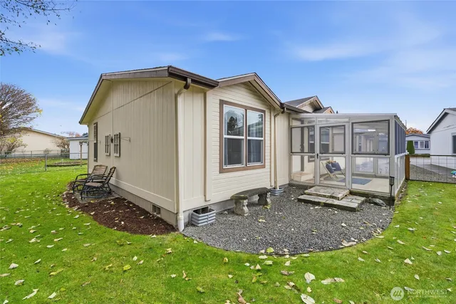 a backyard of a house with table and chairs