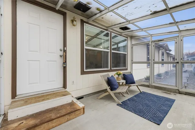 a living room with a couch and a floor to ceiling window