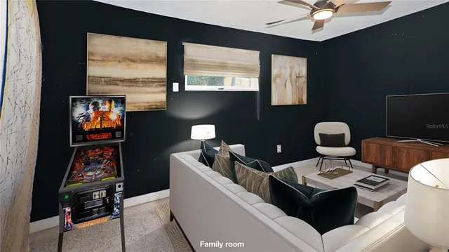 a living room with furniture and a floor to ceiling window