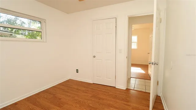 a view of empty room with wooden floor