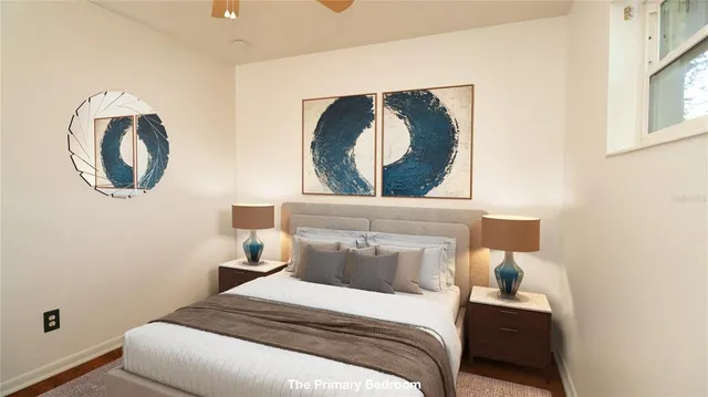 a bedroom with a bed and a painting on the wall