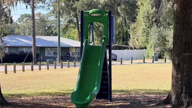 a view of a park with swings and slides