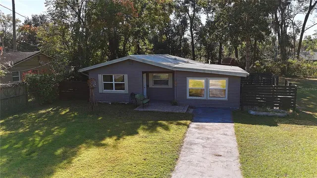 a view of a house with backyard porch and garden