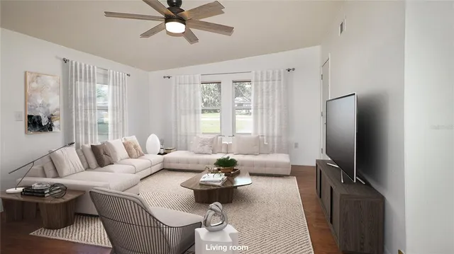 a living room with furniture a large window and a flat screen tv
