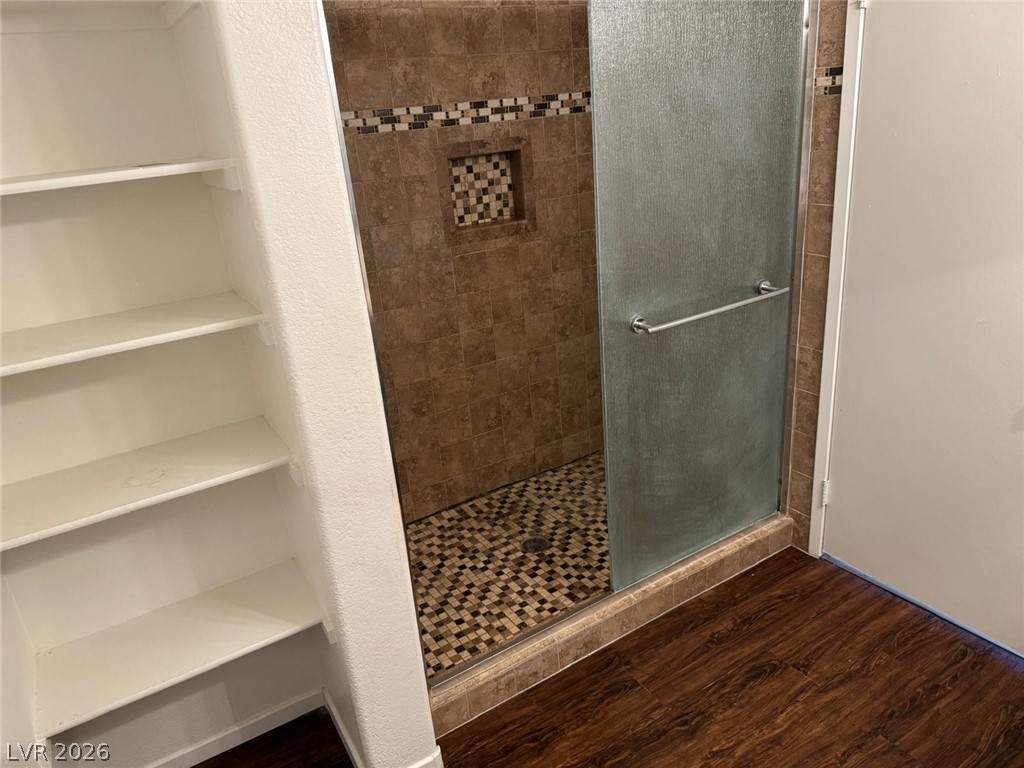 7885 West Flamingo Road, Unit 2171 Las Vegas, NV 89147 - Photo 13 of 22 Modern shower stall with intricate tile work and convenient built-in shelving.