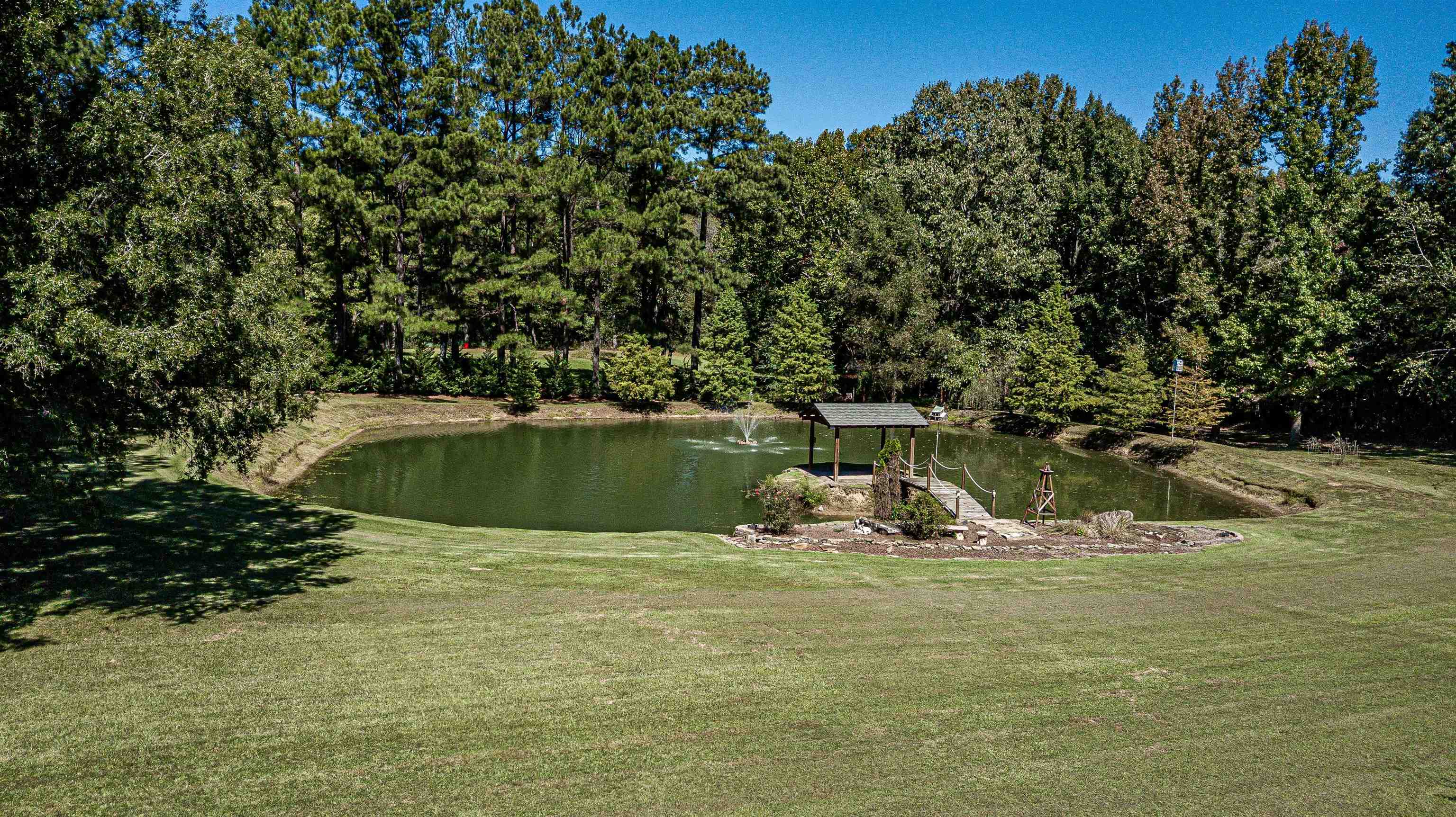 710 Poplar Acres Road Piperton, TN 38017 - Photo 23 of 24 The pond has a metal framed bridge, a pavilion, and a fountain. Vacation in your backyard!