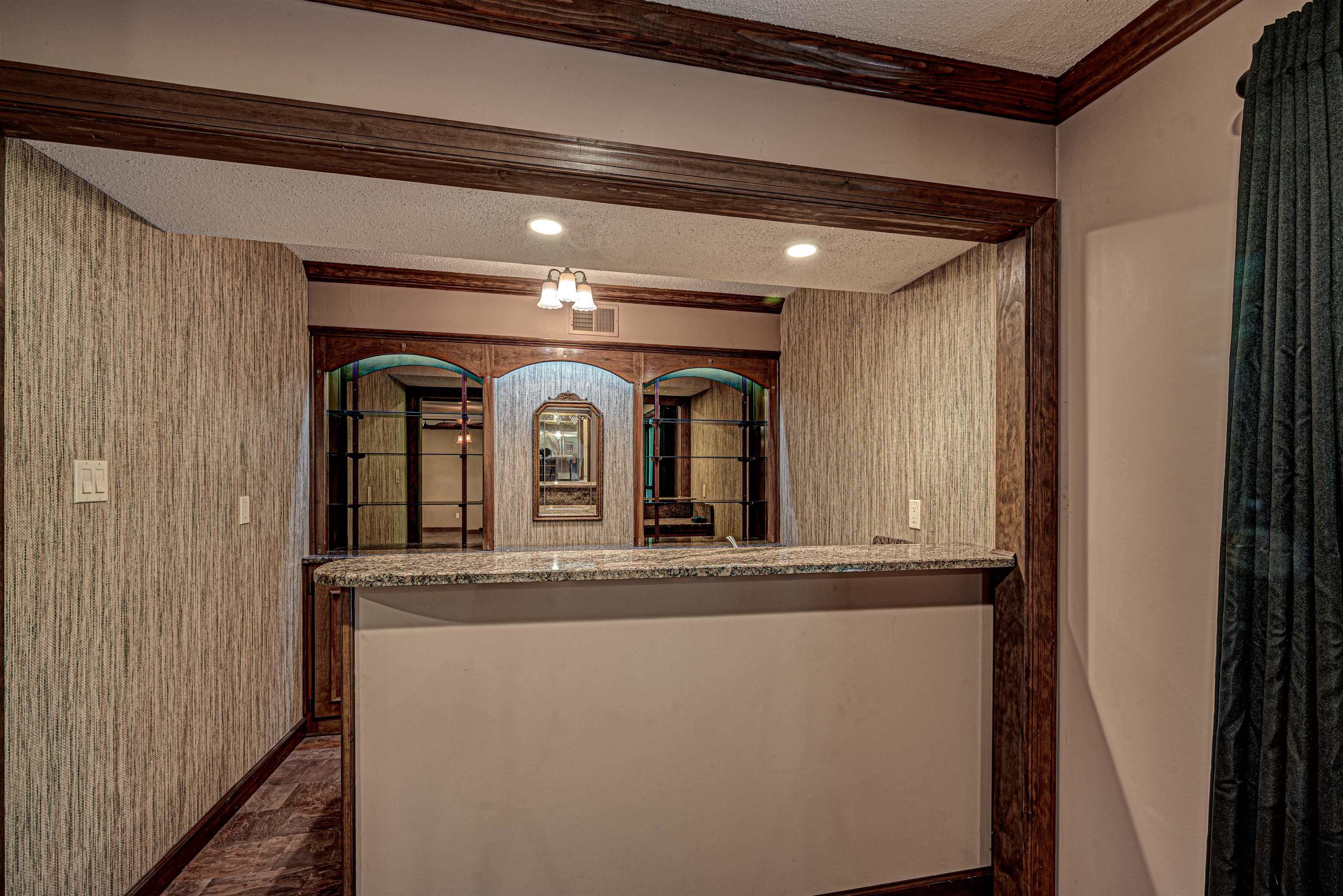 710 Poplar Acres Road Piperton, TN 38017 - Photo 8 of 24 The bar has a sink, built-in refrigerator, and storage cabinets with display shelves.