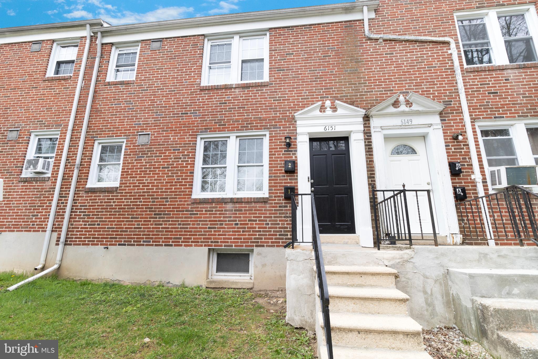 6151 Chinquapin Parkway Baltimore, MD 21239 - Photo 1 of 22 a front view of a house with a garden