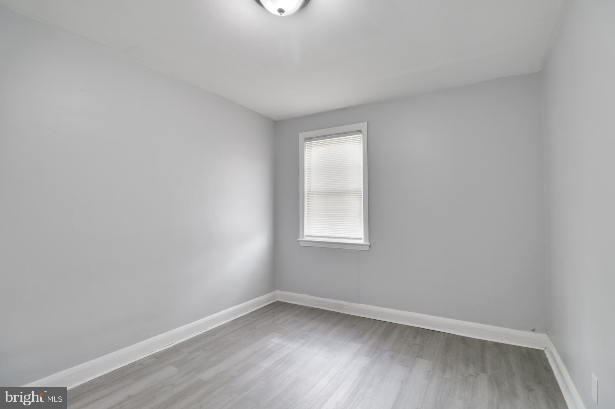6151 Chinquapin Parkway Baltimore, MD 21239 - Photo 13 of 22 an empty room with a window