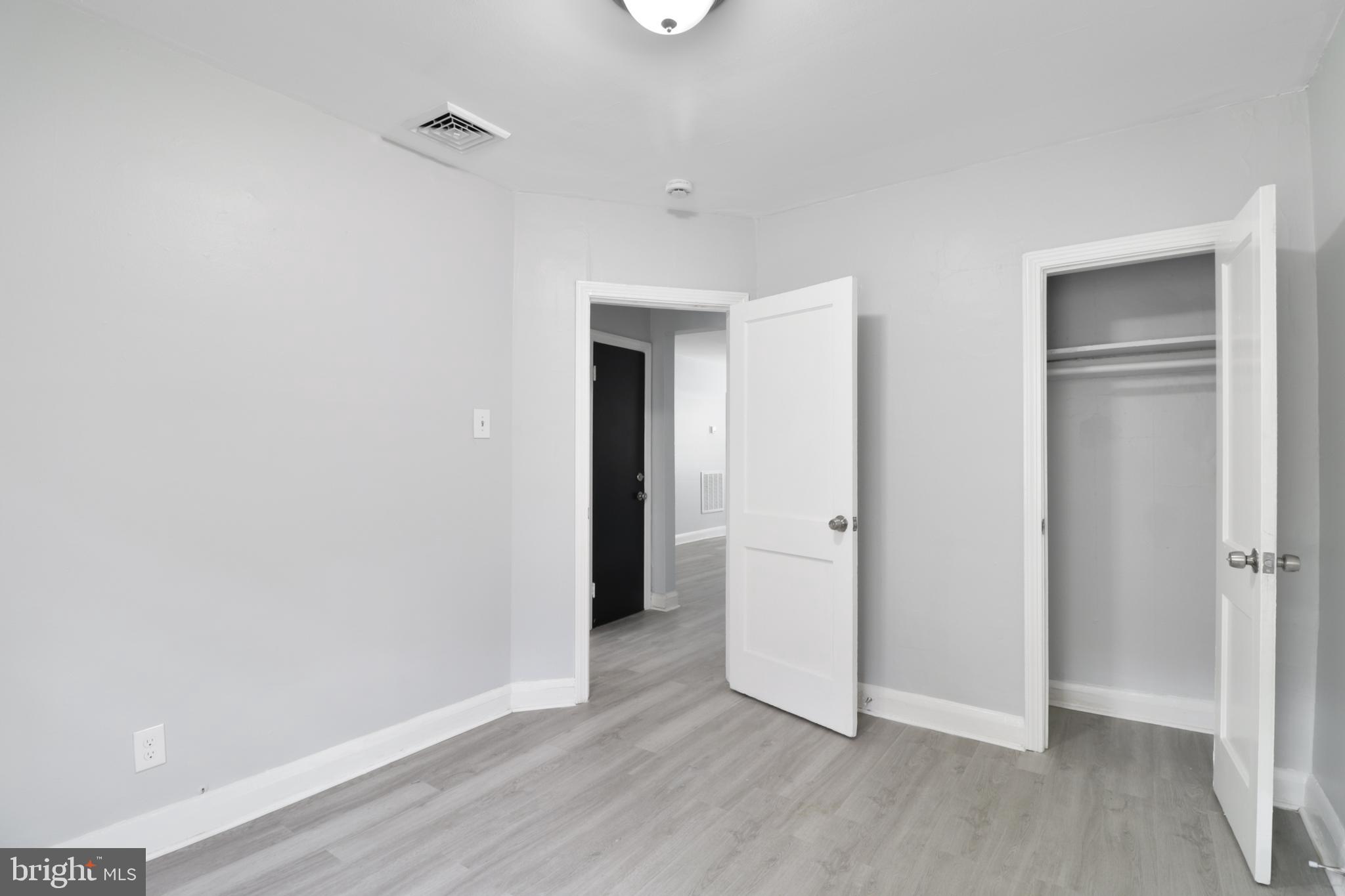 6151 Chinquapin Parkway Baltimore, MD 21239 - Photo 14 of 22 a view of a livingroom with wooden floor and closet area