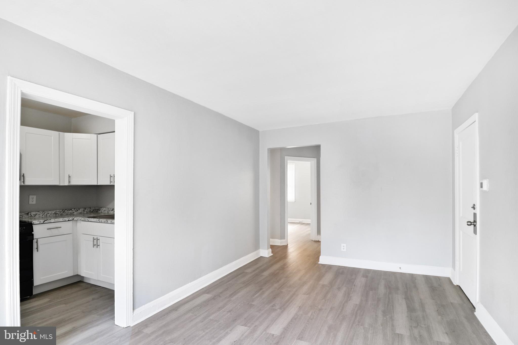 6151 Chinquapin Parkway Baltimore, MD 21239 - Photo 2 of 22 a view of a kitchen with wooden floor and a sink