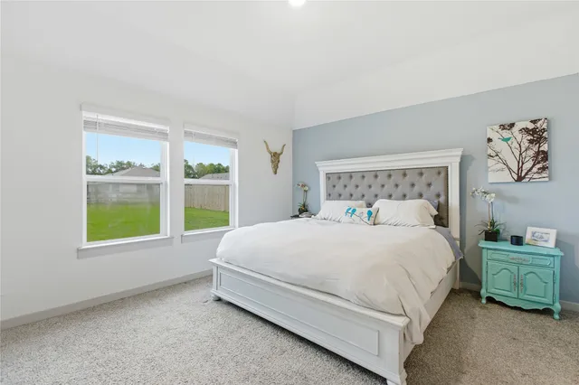 a bed sitting in a bedroom next to a window