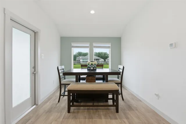 a dining room with furniture and wooden floor