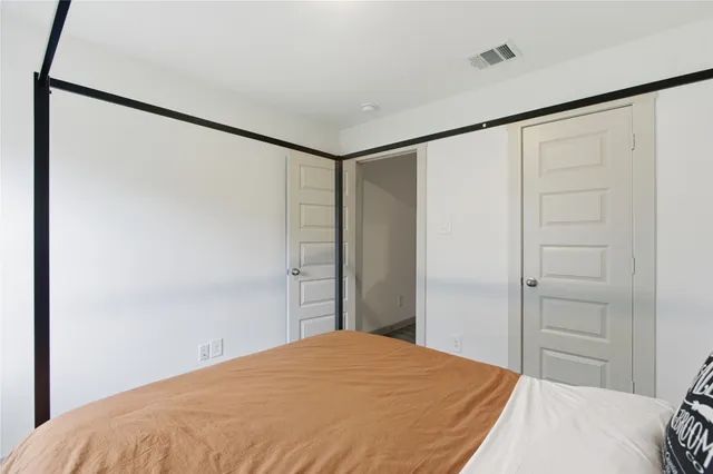 a bedroom with a bed and a shower