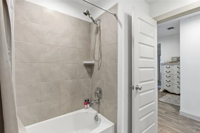 a bathroom with a bathtub and shower