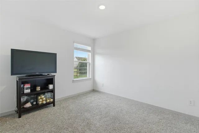 a view of a livingroom with a flat screen tv and a window