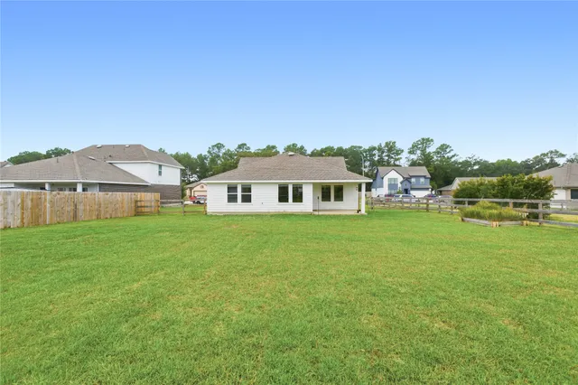 a front view of a house with a garden and yard