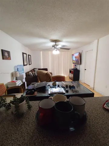 a living room with furniture and a air conditioner vent