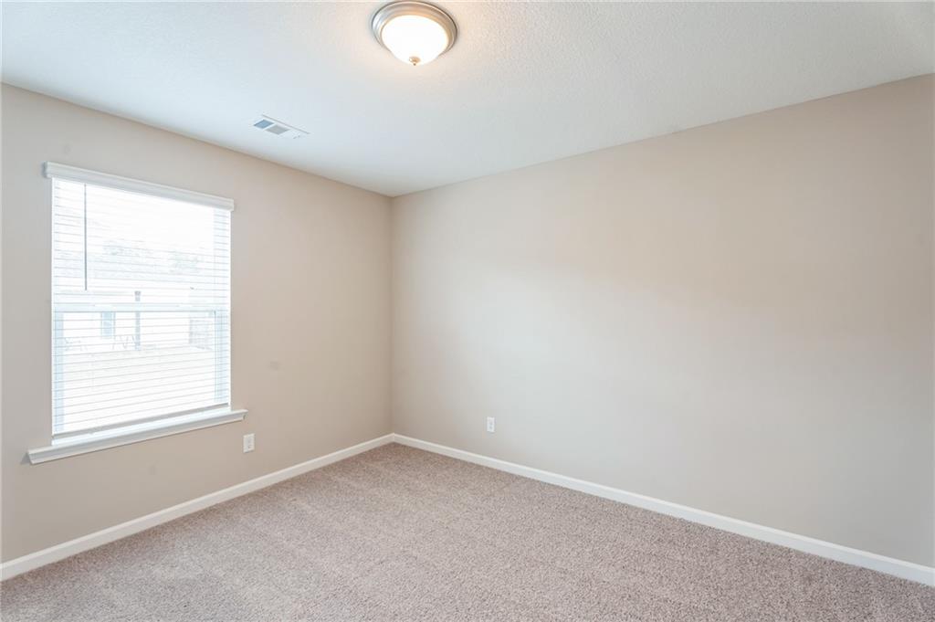 23 Whiterock Road Phenix City, AL 36869 - Photo 21 of 29 Empty room with visible vents, carpet flooring, and baseboards