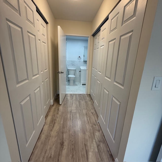 400 East 70th Street, Unit 907 Manhattan, NY 10021 - Photo 9 of 13 a view of a hallway with wooden floor and staircase