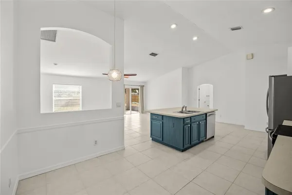 a room with a cabinets and refrigerator