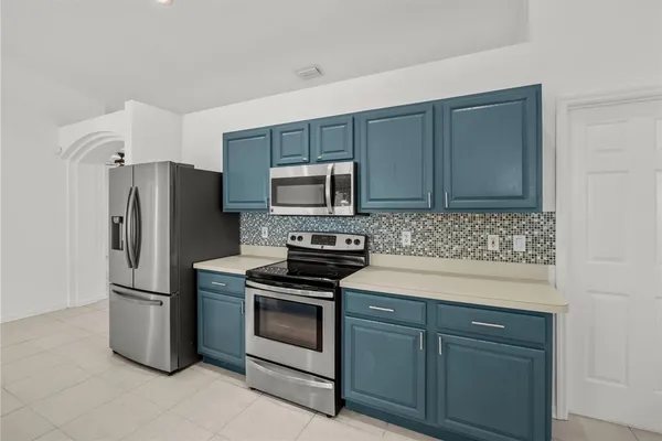a kitchen with a refrigerator sink and microwave
