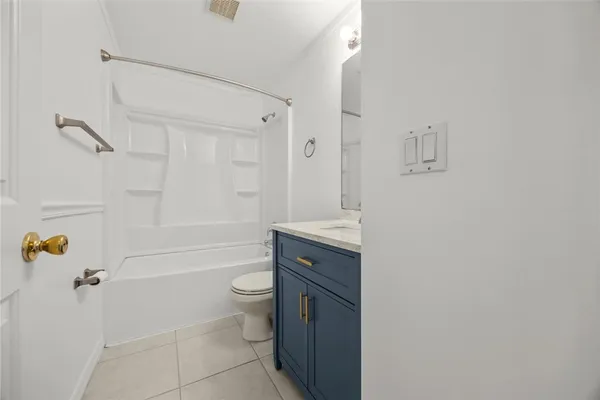 a bathroom with a granite countertop toilet a sink and bathtub
