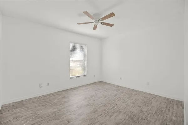 an empty room with closet and windows