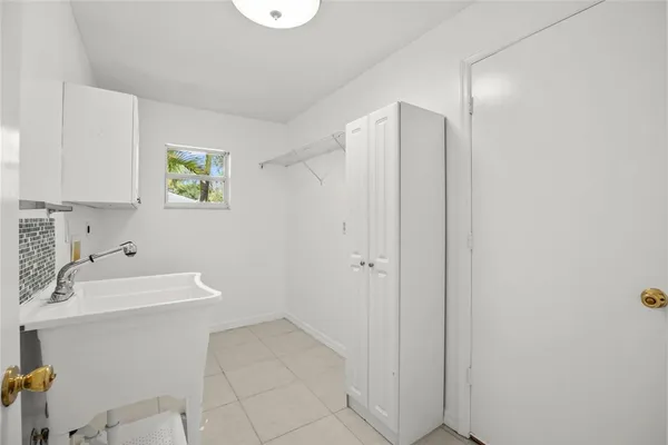 a room with a sink and a mirror