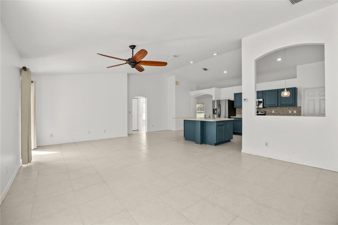 742 46th Square Vero Beach, FL 32968 - Photo 3 of 36 a view of a kitchen with a sink and a fireplace