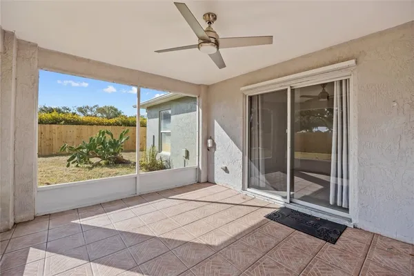 a view of a room with wooden floor and windows