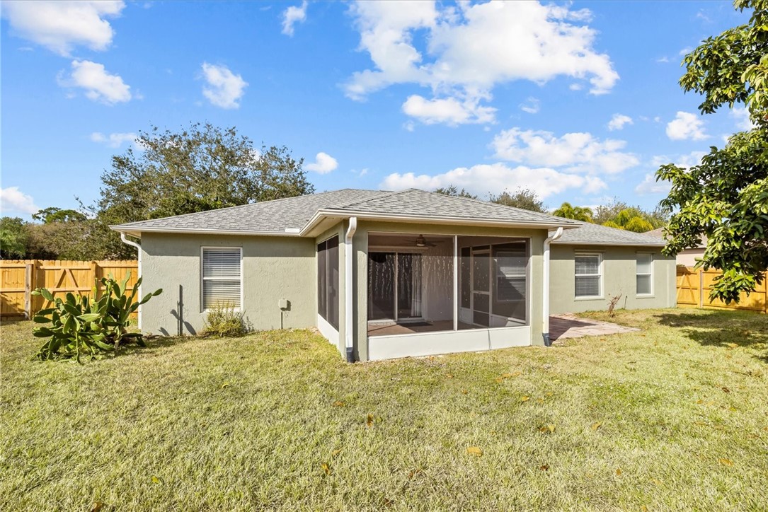 742 46th Square Vero Beach, FL 32968 - Photo 33 of 36 a front view of a house with a garden