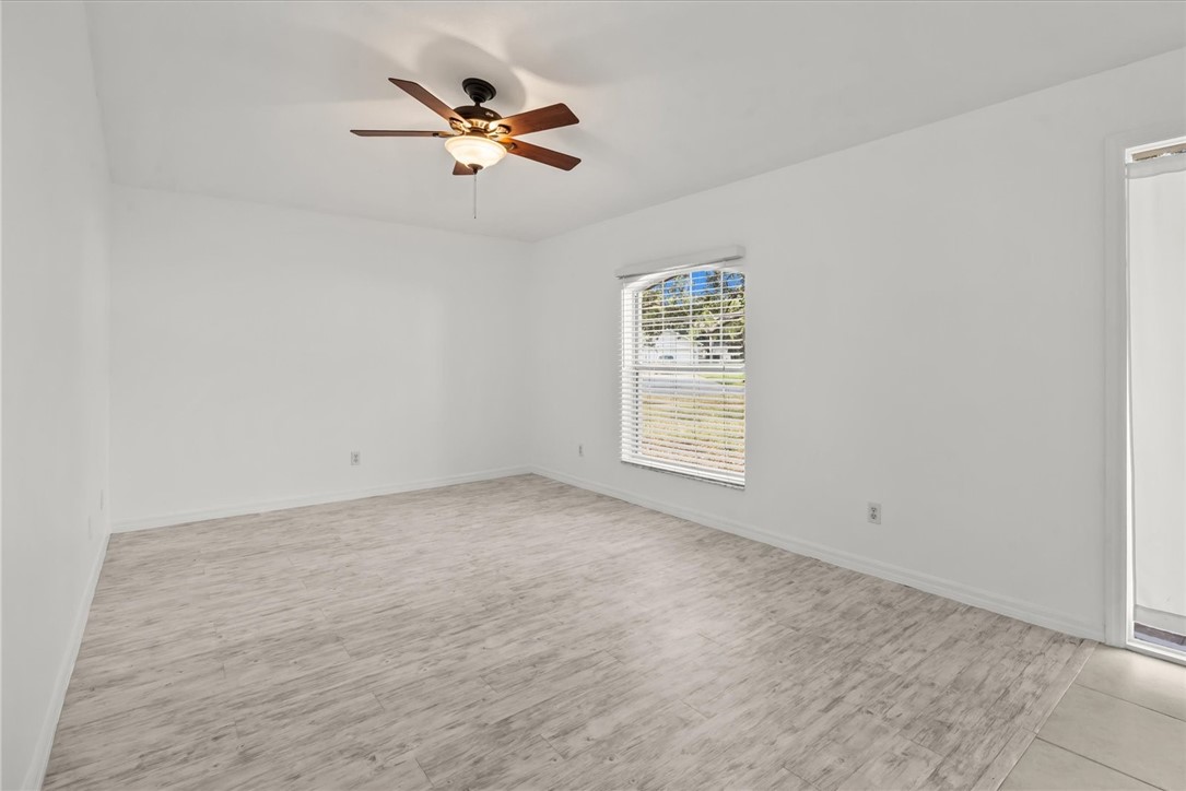 742 46th Square Vero Beach, FL 32968 - Photo 7 of 36 an empty room with a window and a fan