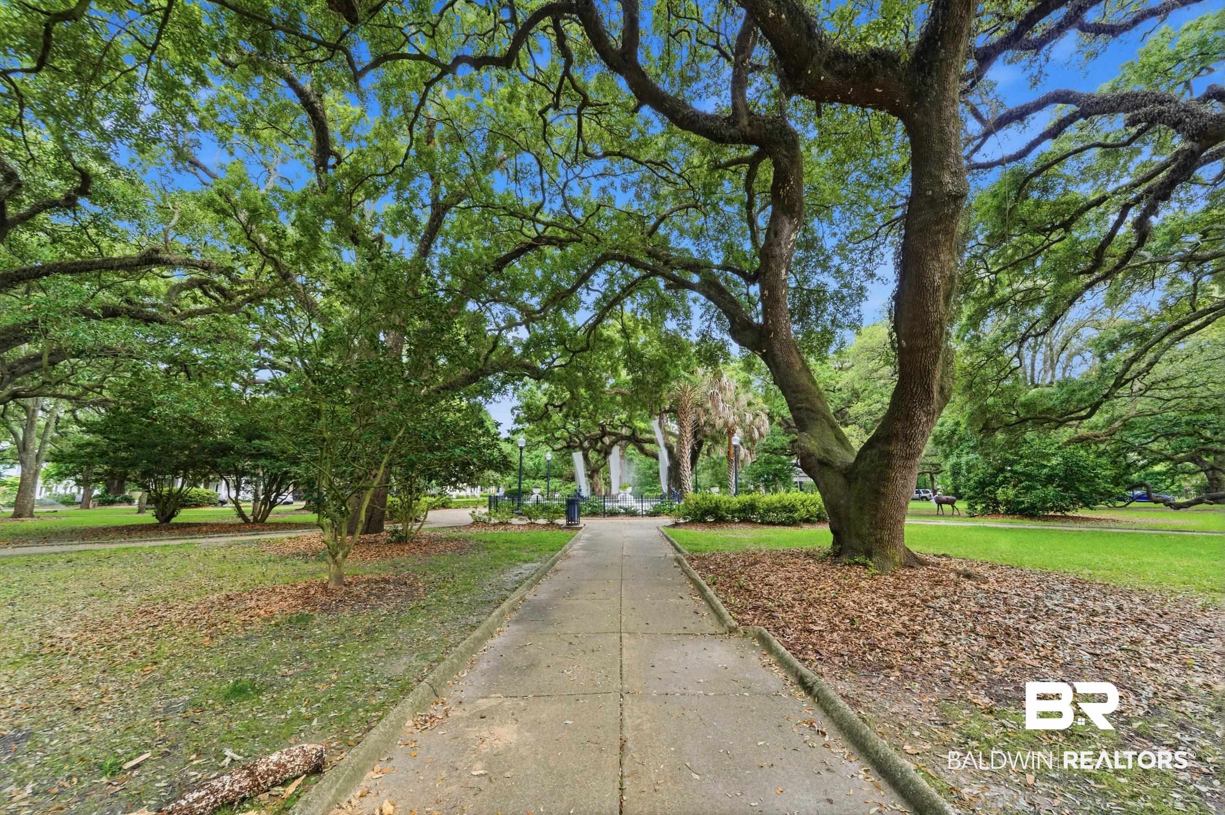 350 Charles Street Mobile, AL 36604 - Photo 50 of 52 Paved pathway through a park-like setting featuring mature, spreading trees and manicured green spaces
