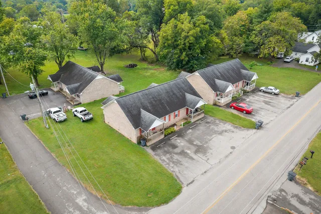 a view of a backyard with plants and outdoor seating