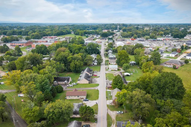 an aerial view of houses with street