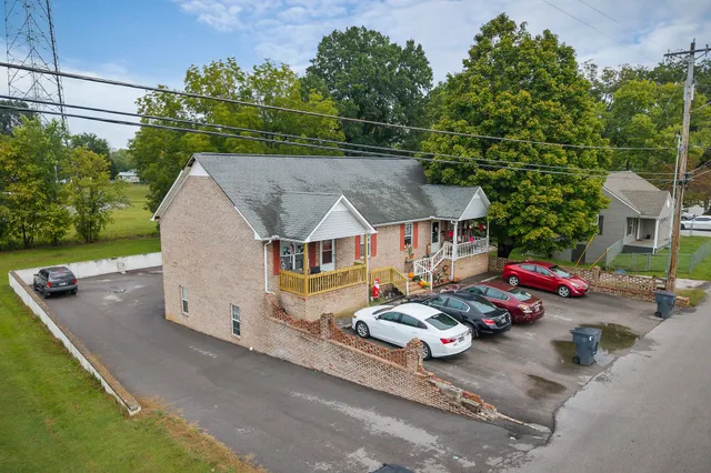an aerial view of a house with garden space and sitting area