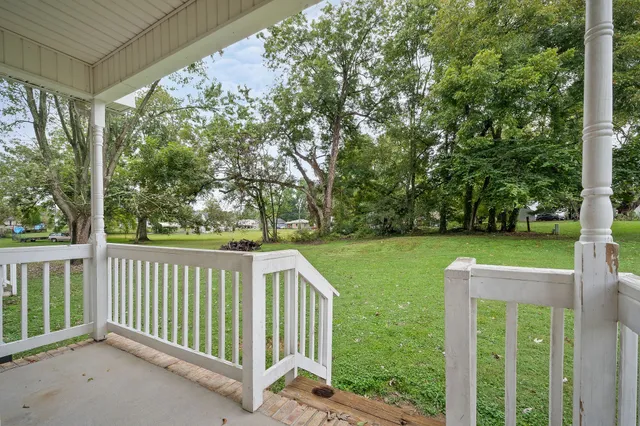 a front view of house with a garden and deck