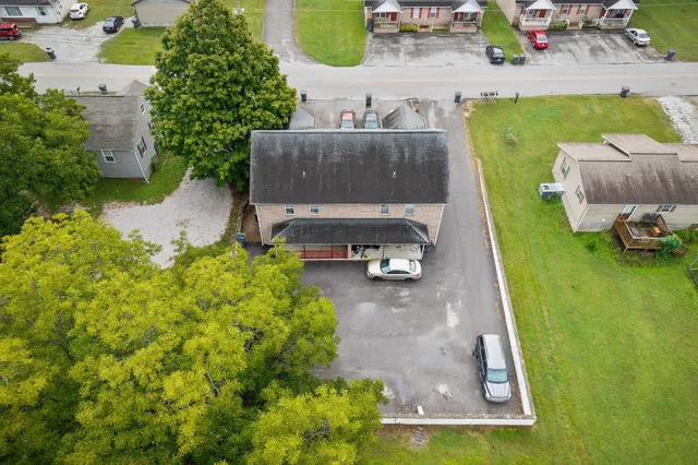 an aerial view of a house with yard swimming pool and outdoor seating