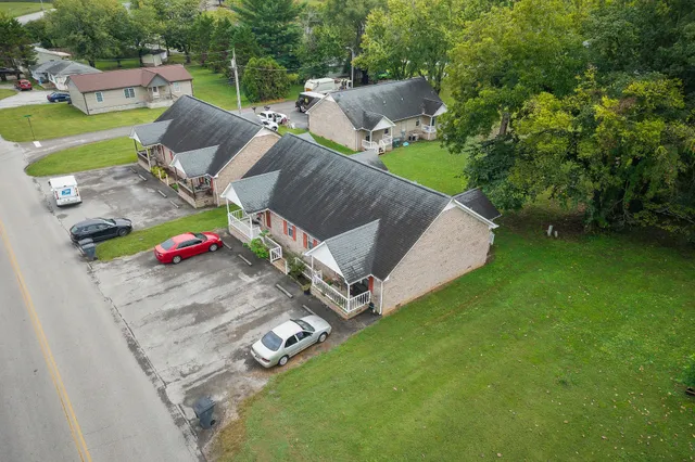 an aerial view of a house with a yard